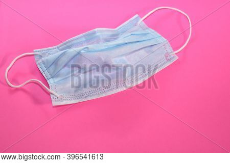 Crumpled Used Protective Medical Mask On A Bright Pink Fuchsi Background. Tired Of Inhibitions, No F