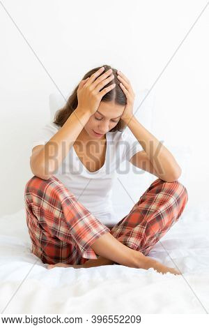 Woman Putting Hand On Head Due To Headache After Waking Up, Filling With Deep Sadness. Migraine. Bea