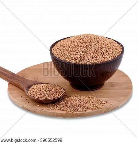 Yellow Indian Mustard Seeds (brassica Alba Boiss) In Brown Bowl On Wood Board Isolated On White Back
