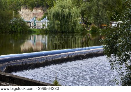 Overflow Of Water Over The Dam On A Sunny Day