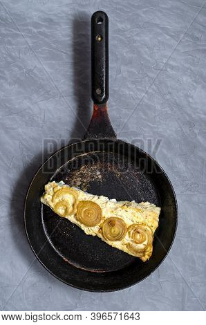 Fried Baked Mackerel Trachurus With Onions And Dried Herbs In An Old Frying Pan. Country Style. Top 