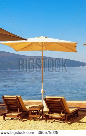 Summer Beach Vacations. Sunny Day At The Beach.  Montenegro, Adriatic Sea, View Of Bay Of Kotor Near