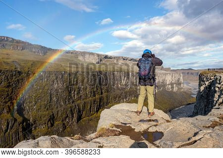 A Photographer Takes Pictures Over A Canyon Near Detifoss Waterfall, Icelands Golden Ring