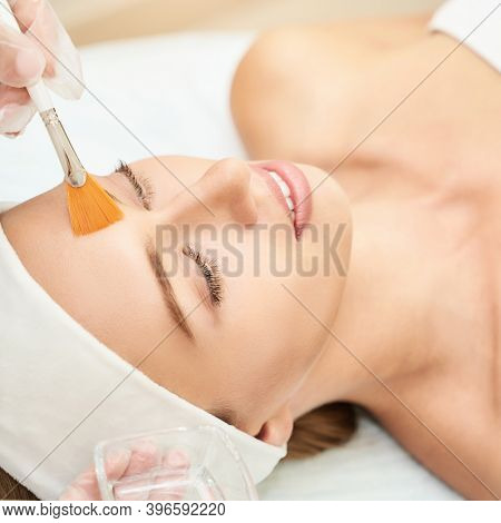 Cosmetology Beauty Procedure. Young Woman Skin Care. Beautiful Female Person. Rejuvenation Treatment