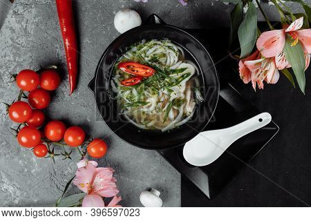 Bowl Of Chicken Noodle On Gray Concrete Background