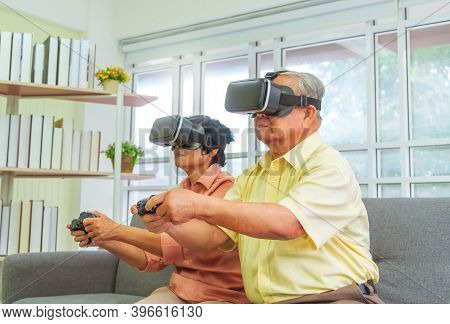 Senior Asian Couple Is Playing Video Game And Wearing Vr Goggles For Retirement Technology Lifestyle