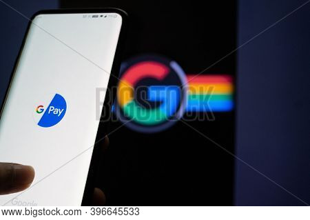 Google Pay App Logged In On A Mobile Infront Of A Black Screen With Google Symbol