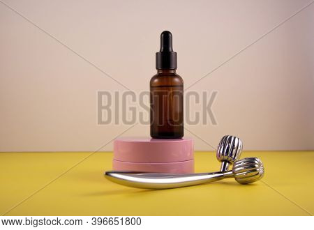 The Concept Of Facial Care And The Fight Against Age-related Changes. Metal Roller, Pink Jar Of Crea