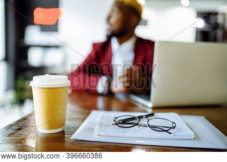 African American Man Getting Online Education And Drinks Coffee To Go Frop Paper Eco Cup