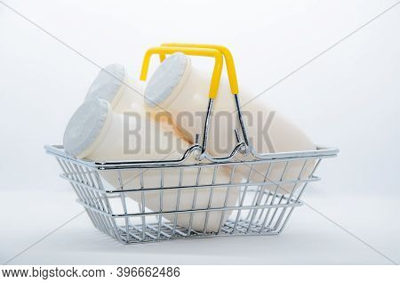 Natural Yogurt With Probiotics And Lactobacillus In Small Plastic Bottles In Metal Shopping Basket O
