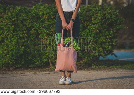 Woman With Pink Reusable Eco Bag With Fresh Bio Vegetables. Plant Based Vegan Diet Shopping. Healthy