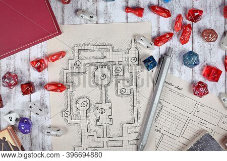 Tabletop Role Playing Flat Lay With Rpg Game Dices, Hand Drawn Character Sheet, Dungeon Map And Pen 