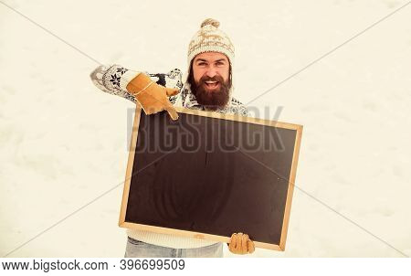 Look Here. Bearded Man In Warm Clothes. Happy New Year. Happy Hipster With Blackboard. Man Advertisi