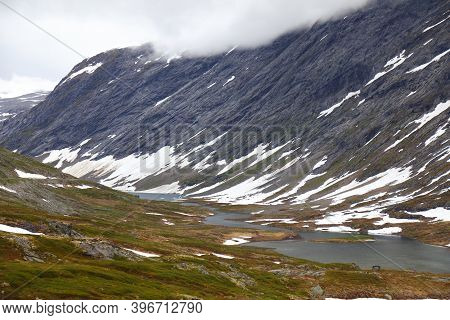 Winter In Summer - Snow In Norway. Sunnmore Alps Mountain Landscape.