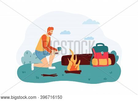 Man Sitting Near Campfire And Drinking Cup Of Tea Near Log. Male Tourist Or Hiker With Backpack On S