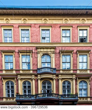 Budapest, Hungary, Aug 2019, view of the upper part of a terracotta colour building with balconies