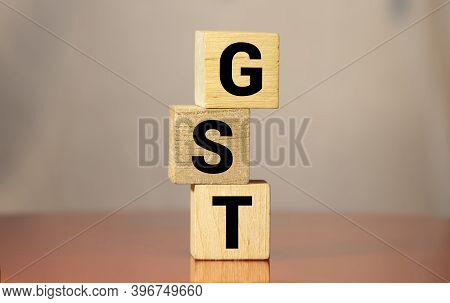 Gst Word Written On Wood Block. Gst Text On Wooden Table For Your Desing, Concept