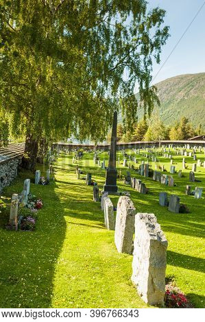 Lom, Norway - July 7, 2018: Graveyard With Old Tombstones Around Lom Stave Church In Oppland County,