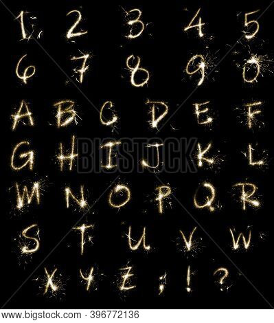 Set With Letters And Numbers Made Of Sparkler On Black Background