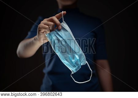 Close Up Shot Of Hands Holding Protective Face Mask.