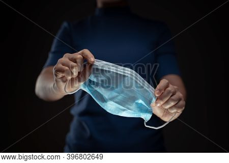 Close Up Shot Of Hands Holding Protective Face Mask.