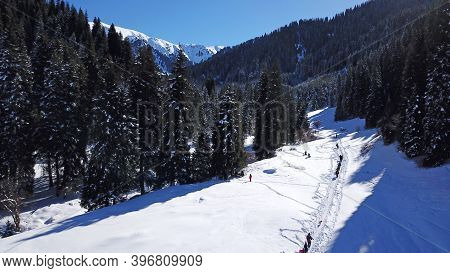 Active Recreation Of People In The Mountains. Top View From The Throne. A Group Of People Walking Al