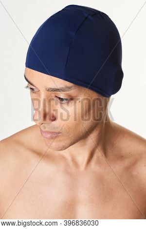 Man wearing a navy blue swimming cap mockup