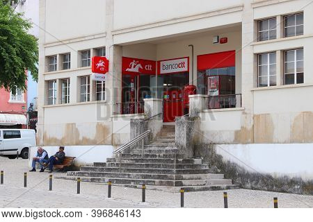 Nazare, Portugal - May 22, 2018: People Sit In Front Of Ctt Correios De Portugal (national Postal Se
