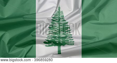 Fabric Flag Of Norfolk Island. Crease Of Norfolk Flag Background, Norfolk Island Pine In A Central W