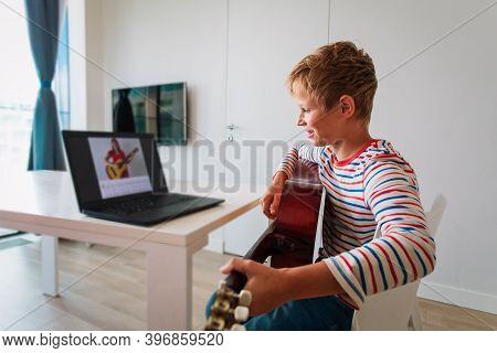 Kid Having Guitar Lesson Online, Teenage Boy On Remote Music Lesson