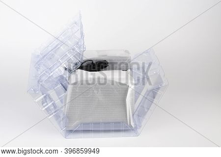 Two Computer Speakers In Transparent Plastic Bag On White Background. In The Middle Between The Spea
