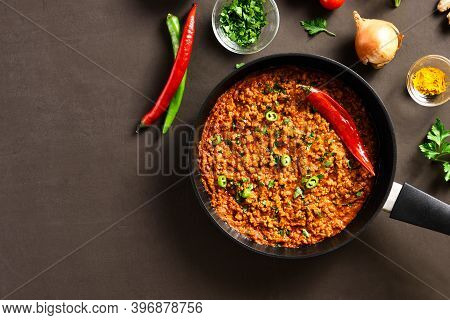 Keema Curry In Frying Pan Over Brown Background With Copy Space. Indian And Pakistani Style Dish. To