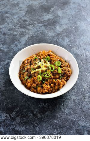 Keema Curry In Bowl Over Blue Stone Background With Copy Space. Indian And Pakistani Style Dish.