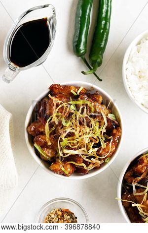 Spicy Garlic Fried Chicken (kkanpunggi). Asian Chicken In Sweet And Sour Sauce In Bowl Over White Ba