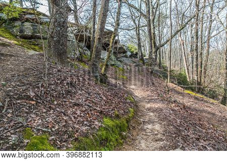 Climbing A Trail High Up Into The Rocky Terrain Of The Cherokee Bluffs Park In Georgia With Fallen L