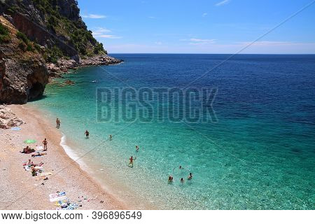 Konavle, Croatia - June 28, 2019: People Spend Vacation At Pasjaca Beach Below Cliffs In Konavle Reg