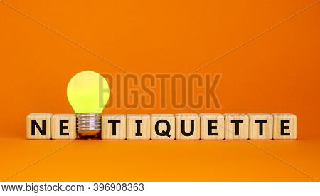 Symbol For Netoquette Time. Wooden Cubes With Word 'netiquette'. Yellow Light Bulb. Beautiful Orange