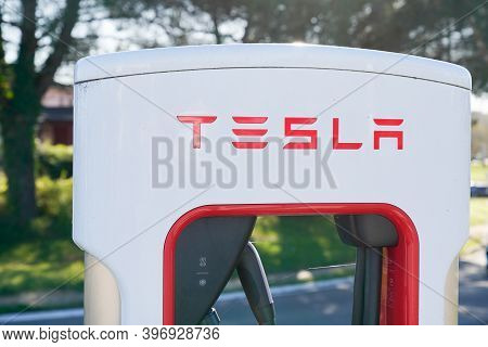 Bordeaux , Aquitaine  France - 11 21 2020 : Tesla Logo Sign On  Supercharger White And Red Station C