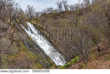 Hokkaido, Japan - May 05 2019 : Oshinkoshin Waterfall On Springtime. One Of Japan Top 100 Waterfalls