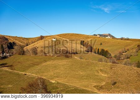 Landscape Of The Lessinia Plateau (altopiano Della Lessinia), In Autumn With Meadows And Tree And Th