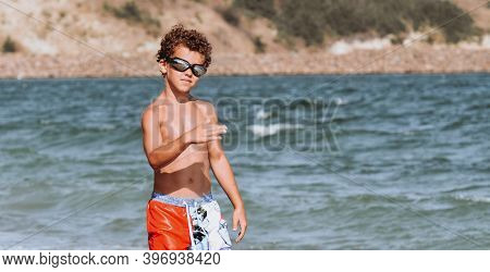 Curly-haired Boy Bathes In The Sea And Laughs