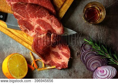 Senza Titolopork Loin Lay On A Chopping Board, Composition With Onion, Rosemary, Orange And Brandy F