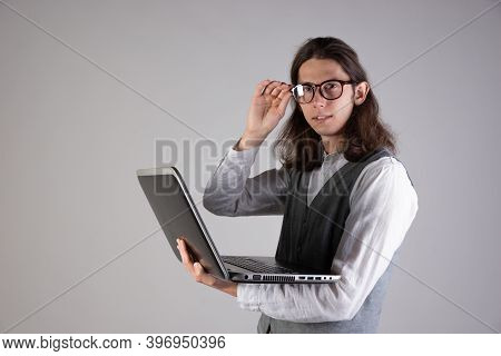 Programming And Writing Code, Developing Software Products. Geek Guy, With Long Hair And Glasses, Ho