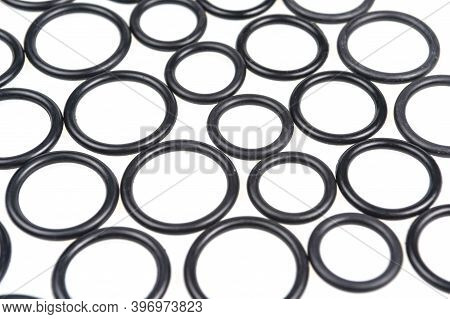Background Of O-rings And Gaskets In Black On A White Background