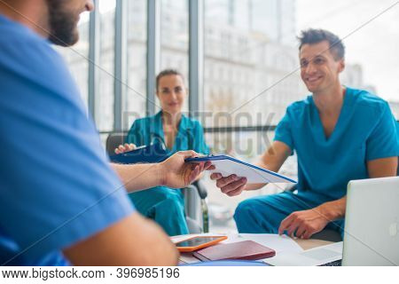 Medical Workers Having A Changeover And Sharing Information