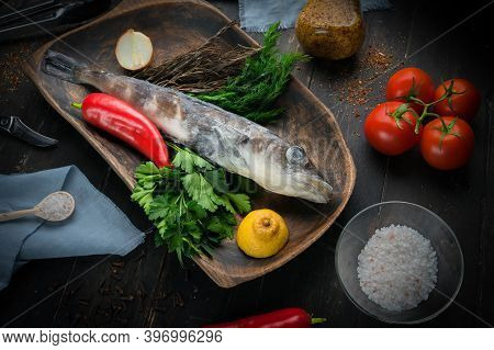 Mackerel Icefish With Ingredients For Cooking In A Wooden Bowl