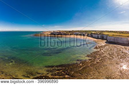 Drone aerial view of the beach and white cliffs on sunny day, Margate, England, UK