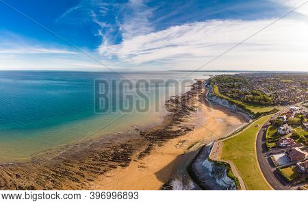 Drone aerial view of the beach and white cliffs on sunny day, Margate, England, UK