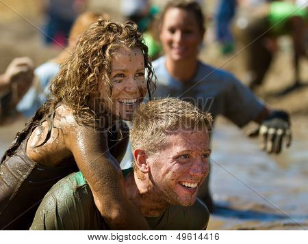 Woman holds on to the back of a man