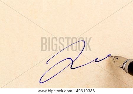 a contract or document is signed by hand with a fountain pen.